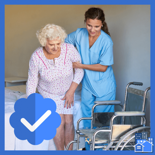 A live in nurse helping an elderly woman out of bed