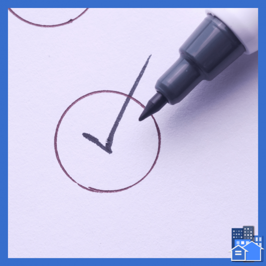 A checkmark inside a circle with a marker to the side of a reasonable accommodation decision form.