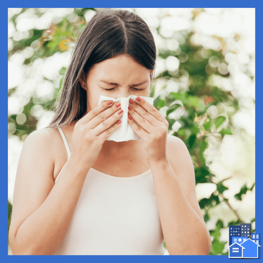 A woman blowing her nose due to allergies and needs to make a request